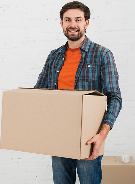 man smiling and holding a cardboard box